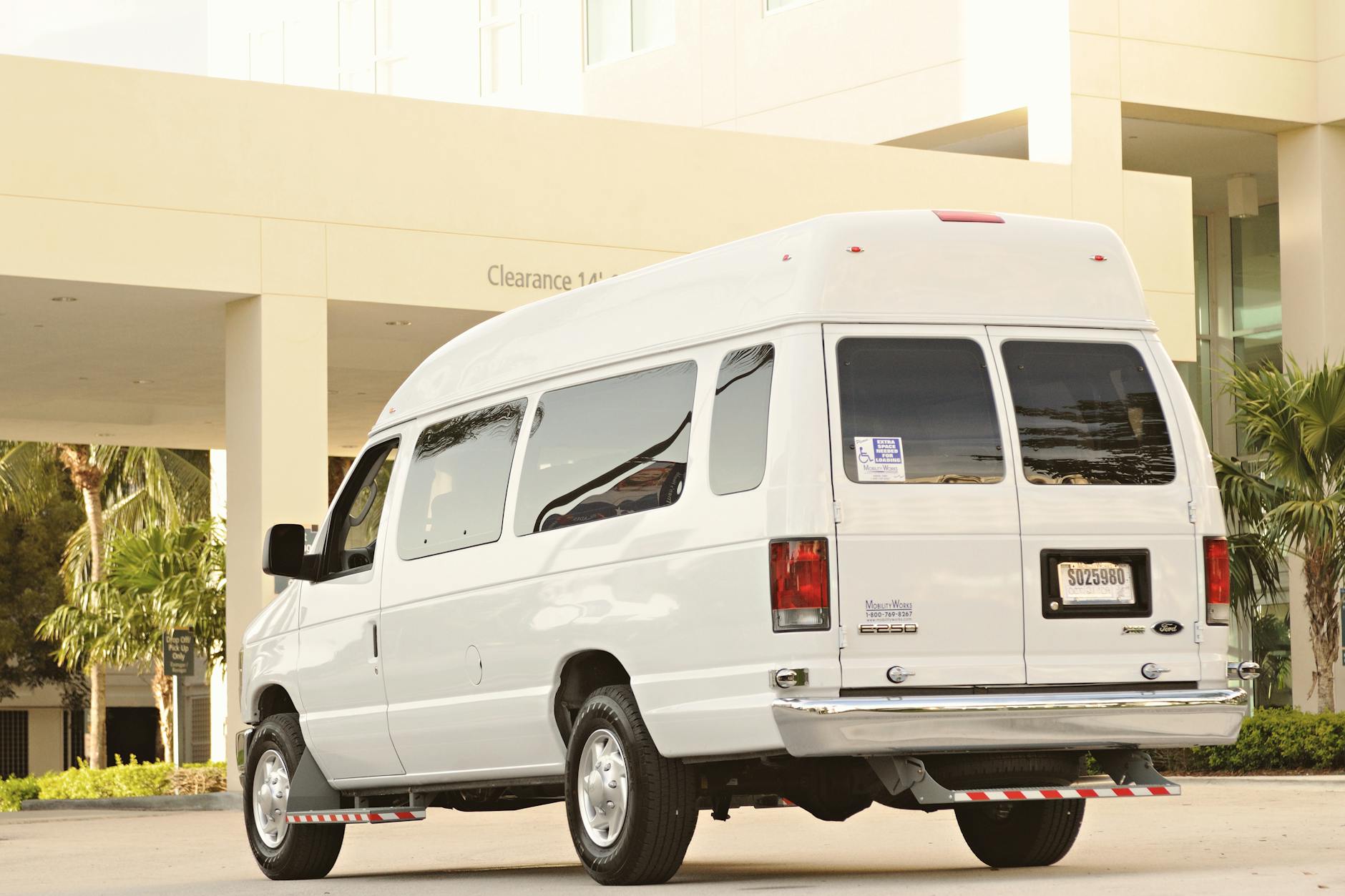 white passenger van in suburban setting